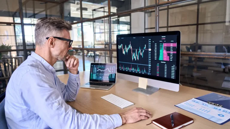 Man looking at analytics on desktop